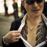 A yakuza street fighter shows off his tattoo. © ANTON KUSTERS, 2011